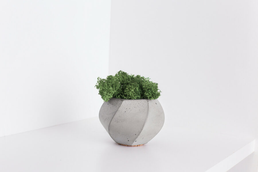 A minimalistic photo with a concrete vase