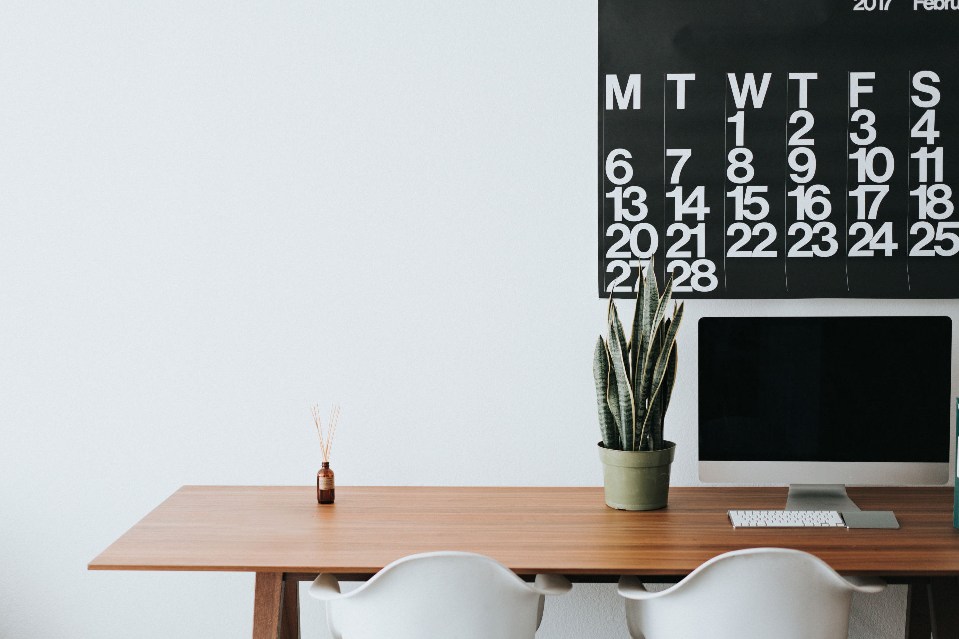 Silver computer on a brown wooden desk
