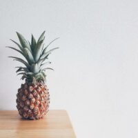 Pineapple on a beige wooden table