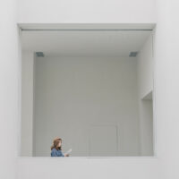 A woman in a blue shirt is reading a book