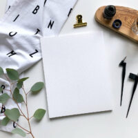 Topview mockup calligraphy with eucalyptus, ink and nibs